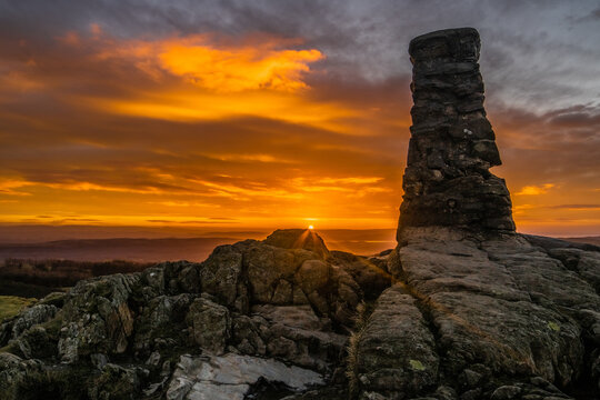 Sunrise view from Gummers How over the Lake District in the UK showing rocks and changing sky colors