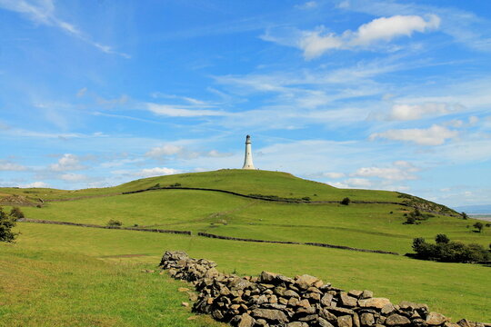 View of Sir John Barrow Monument from Birkrigg Common with Hoad Hill in the background in Ulverston, Cumbria, United Kingdom on a clear day