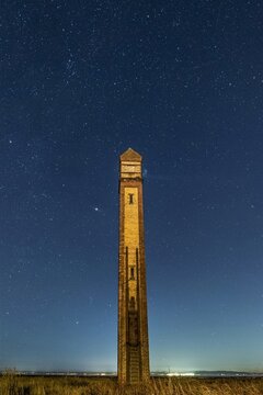 Starry night sky over The Needle tower on the Cumbrian Coast showing historic beacon structure