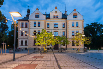 Beautiful illuminated facade of the historic Town Hall (Urzad Miasta) at dusk on the main square in Ustron, Poland. © Jarosław