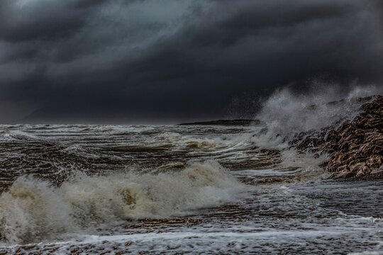 Stormy weather at Walney Island shows strong waves and dark skies on the Cumbrian coast in the United Kingdom