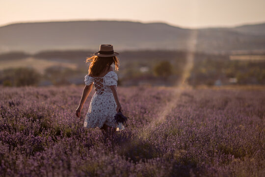Lavender field walking woman straw hat sunset dress summer travel