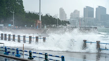Large Waves Crashing Over Coastal Promenade on Stormy Day © zhouyilu