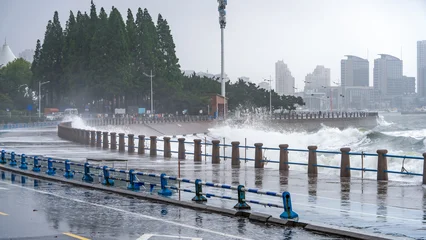 Stormy Sea Waves Crashing Against Coastal Promenade © zhouyilu