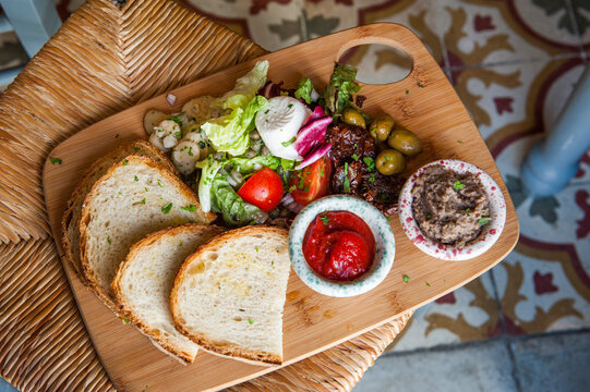 First course served at Diar il-Bniet with fresh bread, salad, and spreads in Dingli during a Mediterranean meal in Malta
