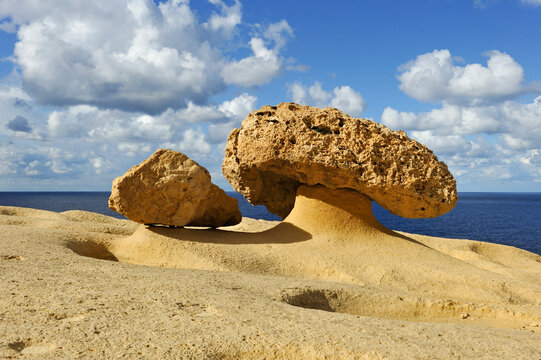 Exploring mushroom rock formations along the northwest coast of Gozo Island near Wied Il-Mielah in Malta