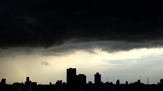 Dramatic timelapse of dark rain clouds sweeping across Bangkok, Thailand.