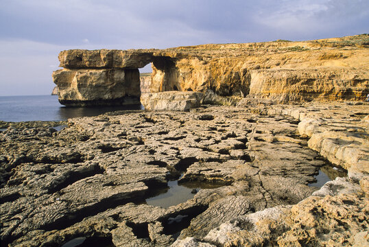 Visit to Azure Window in Dwejra, Gozo on a cloudy day near the Mediterranean Sea in Malta
