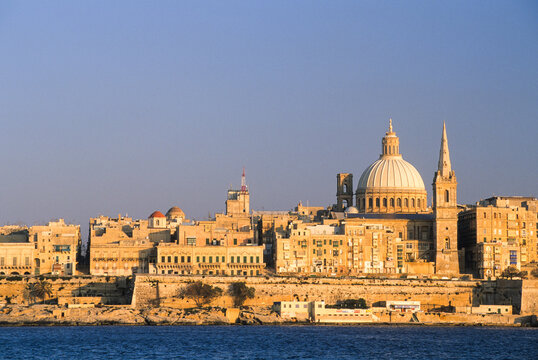 View of St Pauls Pro-Cathedral and Basilica Our Lady of Mount Carmel overlooking the Mediterranean Sea in Valletta Malta during sunset