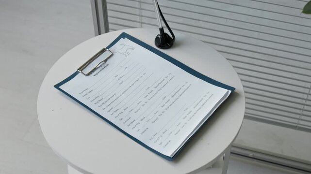 Veterinary hospital registration form lying on clipboard on table, camera zooming in slowly. Footage is perfect for pet insurance ads or veterinary clinic promotional videos