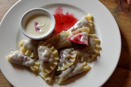 Pierogi with blueberry filling served with cream and berry sauce in the Tatra Mountains region of Poland