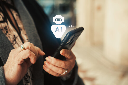AI chatbot assistant on smartphone used by senior woman outdoors. Elderly technology adoption, AI assistants, and mobile connectivity.