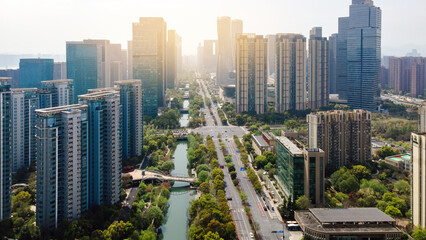 Obraz premium Modern Urban Skyline With River and Tree-lined Avenue