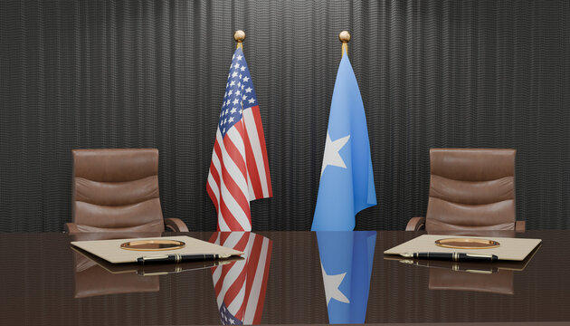 Diplomatic Meeting: Two flags, one of the United States and the other of Somalia, stand behind an empty conference table, symbolizing international diplomacy and negotiation.