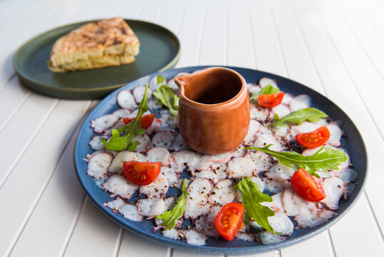 Octopus carpaccio served with tomato and arugula at Ponta da Calheta restaurant, Porto Santo Island