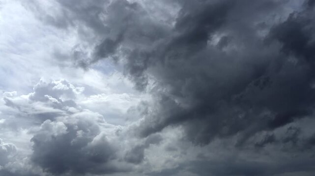 Fast-moving clouds converge in the sky, signaling the arrival of heavy rainfall.