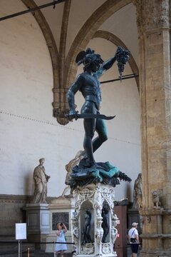 2022/07/21 &ndash; Florence, Italy - View of the famous Perseus with the Head of Medusa sculpture by Benvenuto Cellini displayed in Florence, surrounded by historic architectural elements and museum visitor