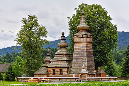 Wooden Greek Catholic Church of St. Paraskevi in Kwiaton, Malopolska Province, Poland located in a rural area surrounded by trees