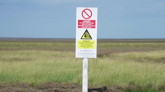 British army base warning signs. Danger of unexploded weapons on a Lincolnshire beach danger of explosions and death. Keep our. Environmental issues and destruction of nature