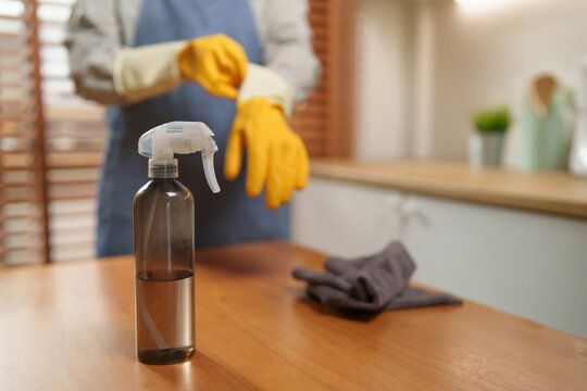 Cleaning spray, microfiber cloth, and rubber gloves prepared for kitchen cleaning, representing hygiene, sanitation, and efficient household maintenance in a modern home.