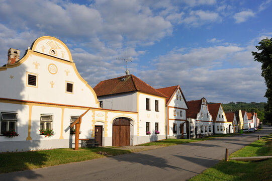 Historic buildings line the street in Holasovice village showcasing traditional architecture in Czech Republic