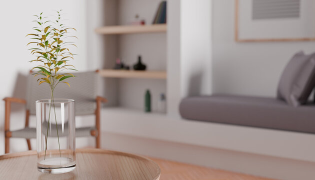 Minimalist Interior Serenity: A delicate green plant in a clear glass vase rests on a wooden coffee table, exuding tranquility within a serene.