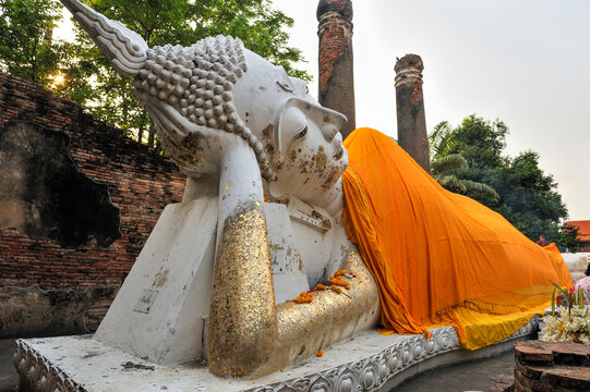 Reclining Buddha sculpture at Wat Yai Chai Mongkol in Ayutthaya attracts visitors from around the world