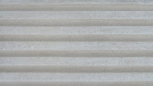 Gray grey 3d ribbed bright concrete wall, cement tile texture background