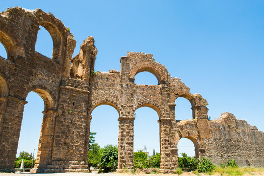 Exploring the remains of the Roman aqueduct at Aspendos in Antalya, Turkey during a clear day