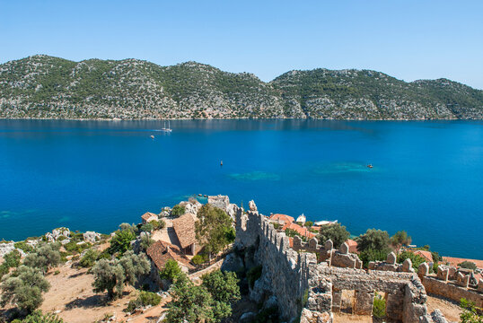 View of Kalekoy from Byzantime castle in Kekova bay, Turkey with clear blue waters and green hills