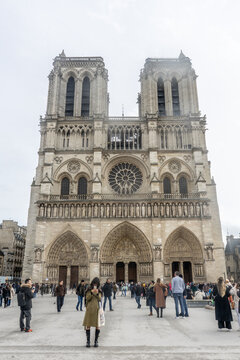 Crowds gather at Notre Dame Cathedral's forecourt on a winter day in Paris, France