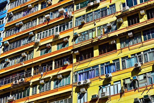 Colorful apartments in an urban area showcase a bustling lifestyle in Mong Kok, Hong Kong with many air conditioning units
