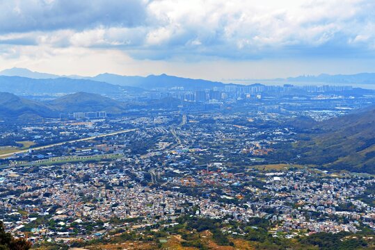 View of Yuen Long District from Tai To Yan Ridge Trail in Hong Kong, showcasing the landscape and urban environment