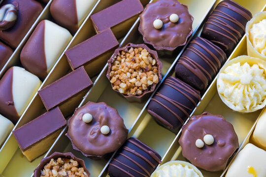Chocolate and caramel cakes with nuts arranged in a box