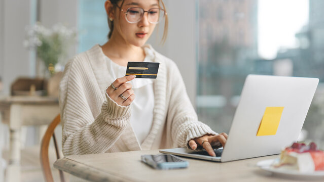 Young adult business asian woman using credit card shopping online or banking payment, digital wallet paying