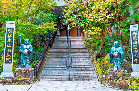 Visitors walk up the steps of Nanzoin Temple in Fukuoka, Kyushu, while exploring its surrounding gardens and sculptures