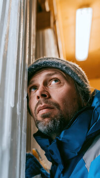 Climatologist with a deep ice core sample in a freezing locker, unscripted emotional moment