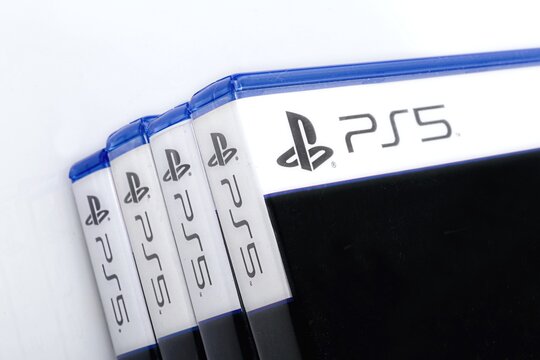 Close-up of PS5 game cases on white background. 