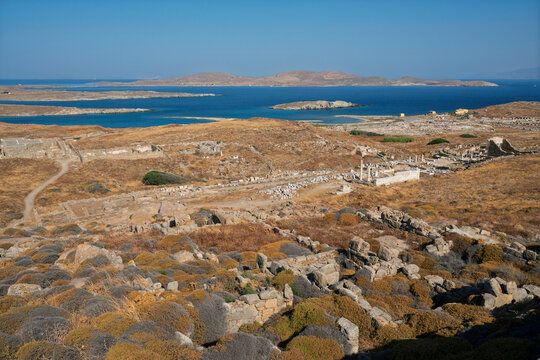 Exploration of the Delos archaeological site surrounded by the sea in the Cyclades archipelago, Greece, during a clear day