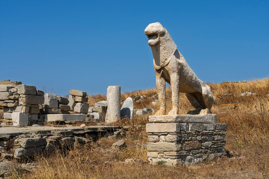Discover statues of lions at a historical site in Greece with clear blue sky