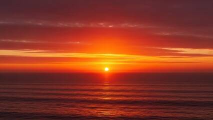 Fototapeta premium Golden sun dips into calm red ocean at sunset, reflecting brightly