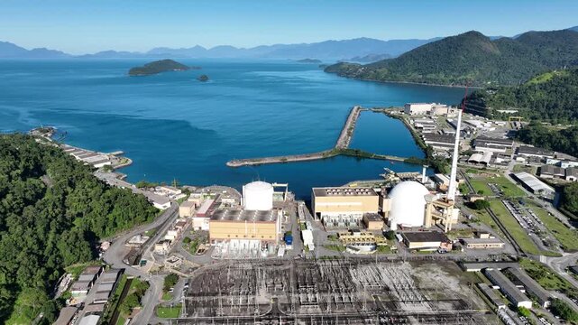 Nuclear energy as an alternative energy source. Operational nuclear power plant. Aerial view. establishing shot.