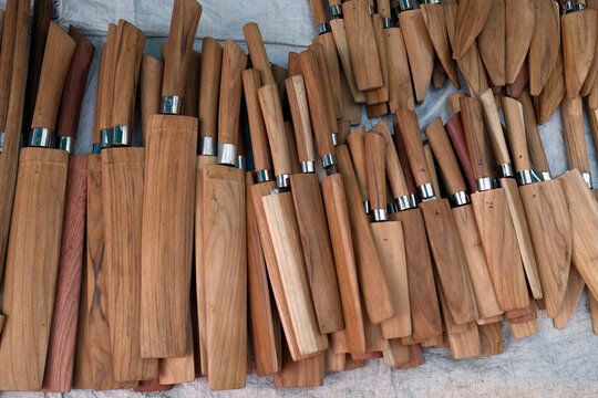 Knives displayed for sale at a local market in Luang Prabang, Laos, highlighting traditional craftsmanship and local trade practices