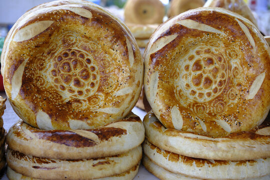 Fresh bread displayed at a food market in Bukhara, Uzbekistan during the daytime