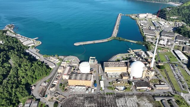 Nuclear energy as an alternative energy source. Operational nuclear power plant. Aerial view. establishing shot.