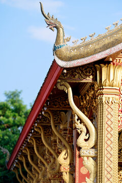 Golden dragon sculptures at Wat Nong Sikhounmuang temple in Luang Prabang, Laos, showcasing traditional Buddhist art and architecture