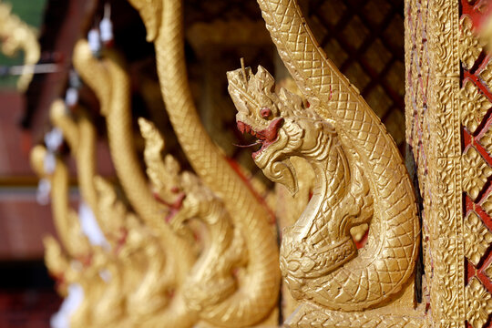 Golden dragon sculptures at Wat Phramahathat Rajbovoravihane in Luang Prabang showcase traditional Buddhist art