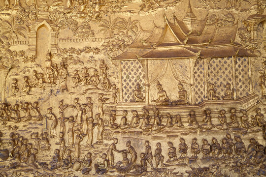 Golden frescoes show episodes from Ramayana at Wat May Souvannapoumaram temple in Luang Prabang, Laos