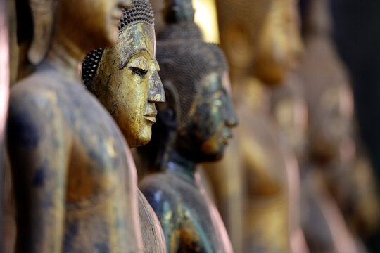 Wooden Buddha statue in calling for rain position at Wat Visounnarath temple, Luang Prabang, Laos, crafted in the 17th to 18th century