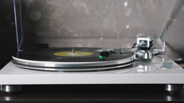 Vintage turntable playing vinyl LP, retro music nostalgia, analog audio experience, spinning record on hi-fi player, classic home entertainment.